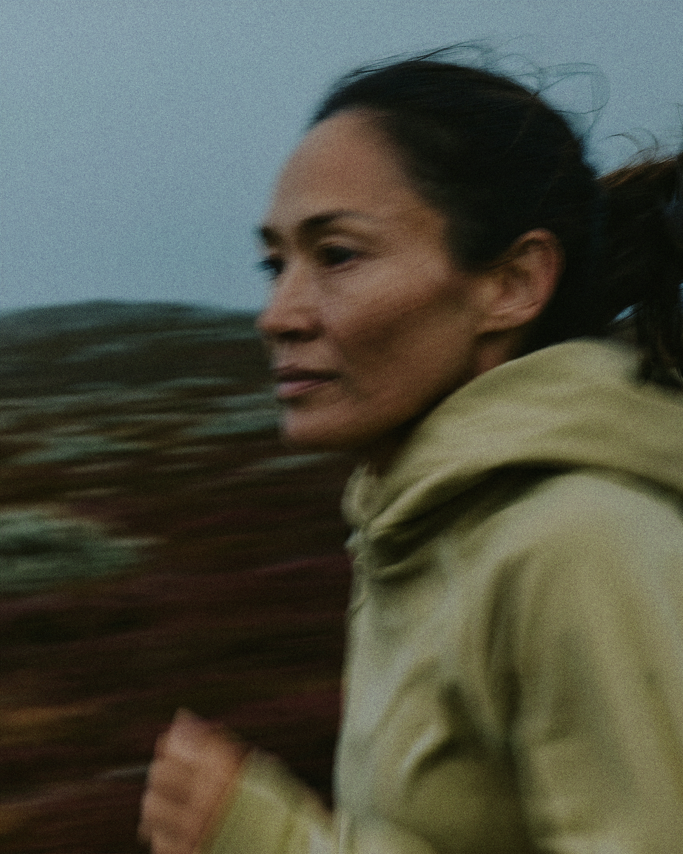 Person running outdoors with a blurred natural background